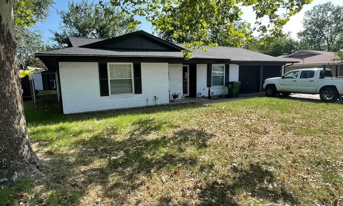 Professional roofing crew working on a residential roof in Eureka